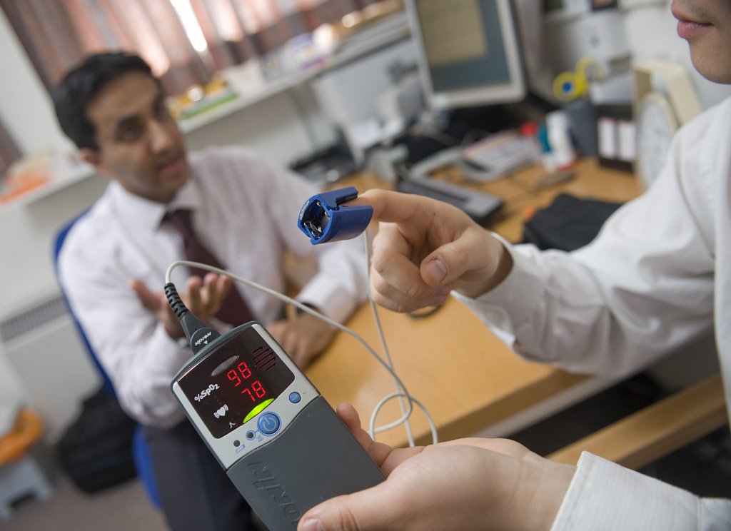 An NHS GP in his surgery